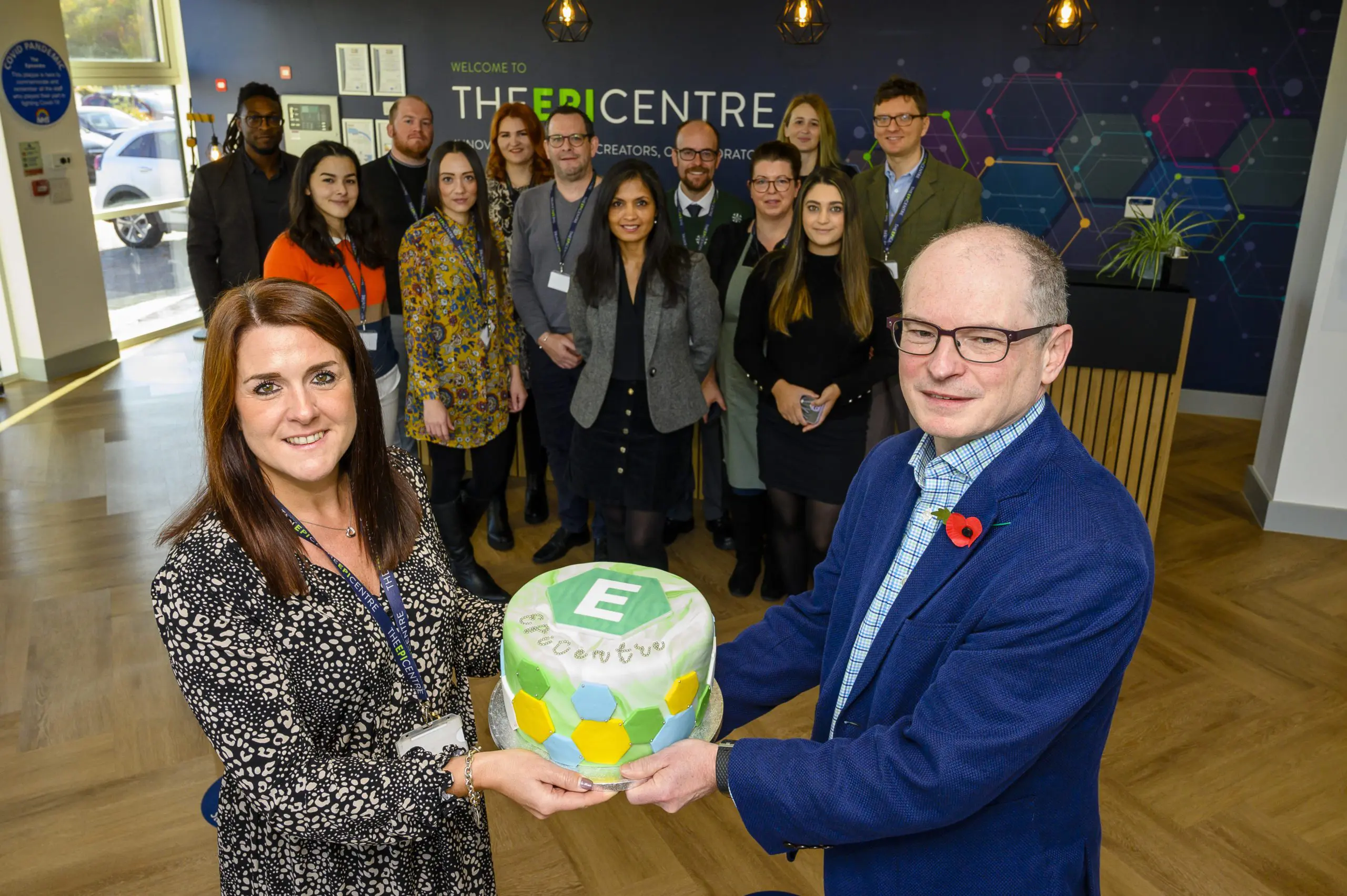 EpiCentre staff holding cake for EpiCentre Birthday