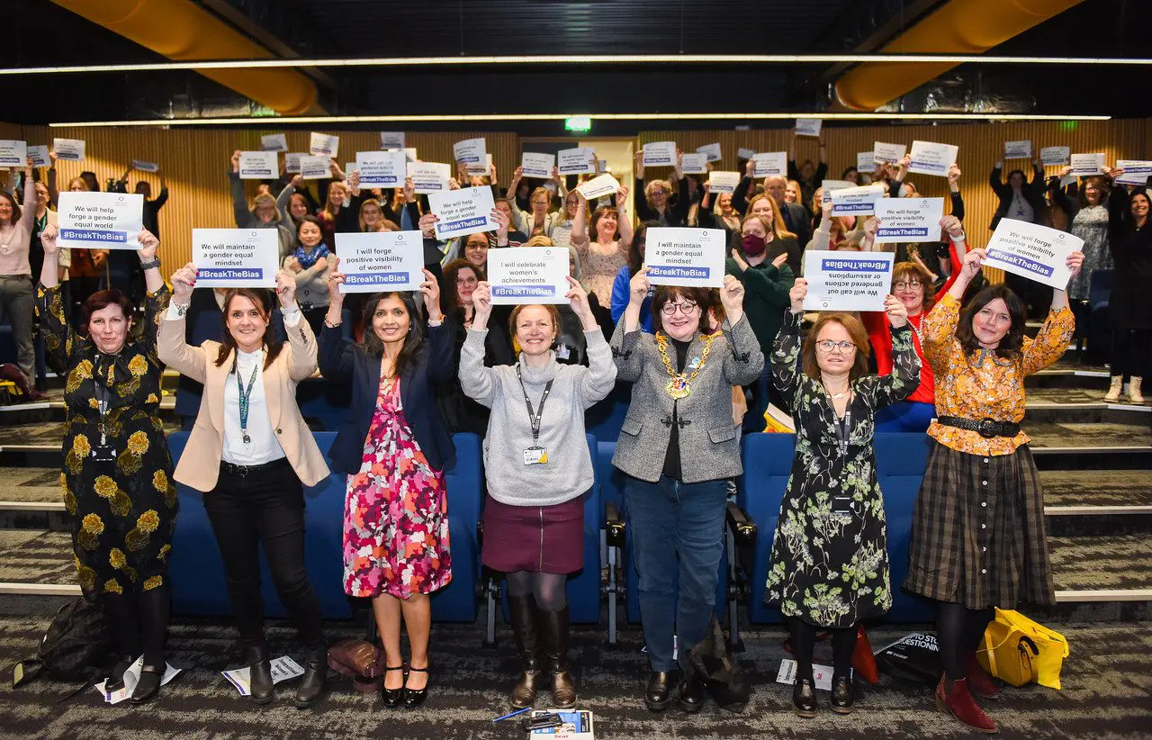 Women Holding #BreakTheBias signs for International Womens Day