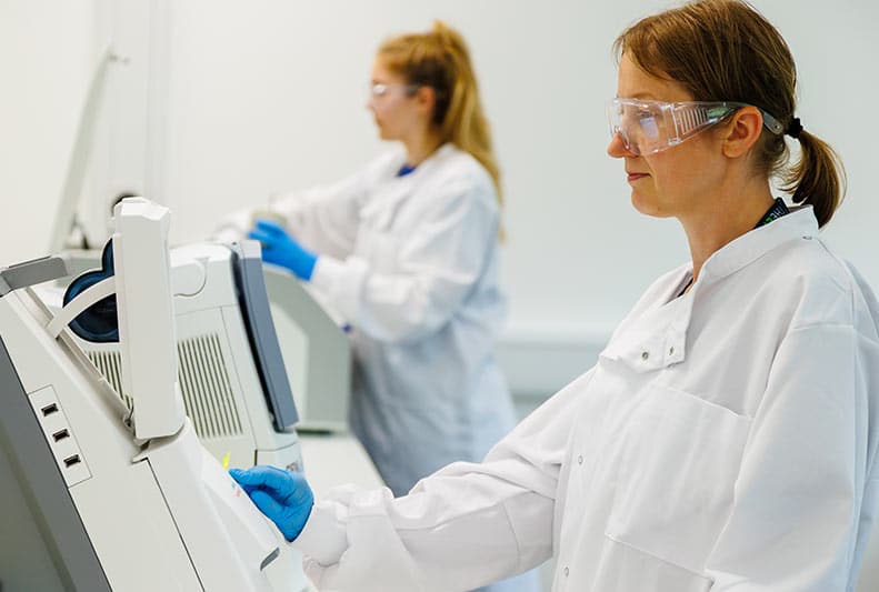 Close up of person operating lab equipment